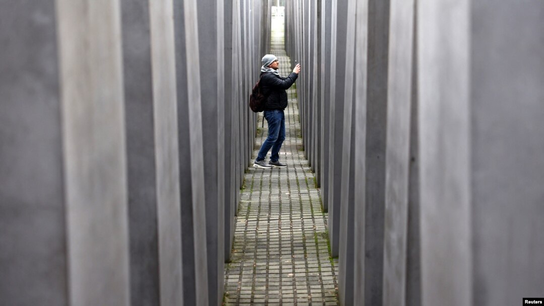 A visitor walks at the Holocaust Memorial to the Murdered Jews of Europe as Germany commemorates the victims of the Holocaust on the eve of the International Holocaust Remembrance Day, in Berlin, Germany, Jan. 26, 2024.