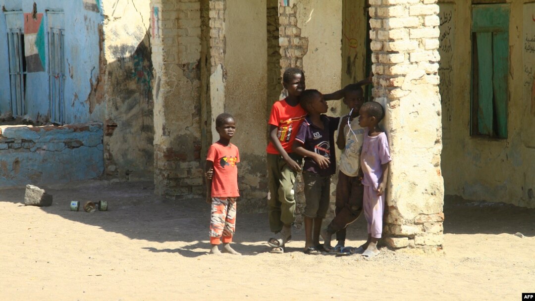 Displaced Sudanese children stand in the courtyard of a school, where their families took refuge, near Gadaref city in war-torn Sudan on March 6, 2024.