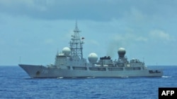 This handout photo taken and released by the Taiwan Coast Guard on May 24, 2024 shows a Chinese military vessel sailing a few miles southeast of Green Island, located off the eastern coast of Taiwan.