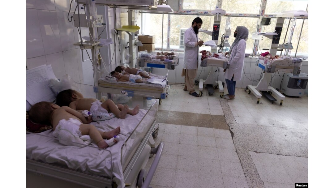 FILE - Doctors work at the maternity ward at the Indira Gandhi hospital in Kabul, Afghanistan, Oct. 24, 2021.