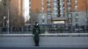 A member of the Chinese People's Armed Police Force wears a face mask as he keeps watch on a street amid COVID-19 outbreaks in Beijing, Dec. 1, 2022.