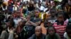 Children watch pro-government supporters gathering for an election rally in Bamako, Mali.