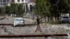 A Houthi rebel fighter walks on a street littered by debris following a Saudi-led airstrike in Yemen's capital, Sana'a, April 20, 2015.