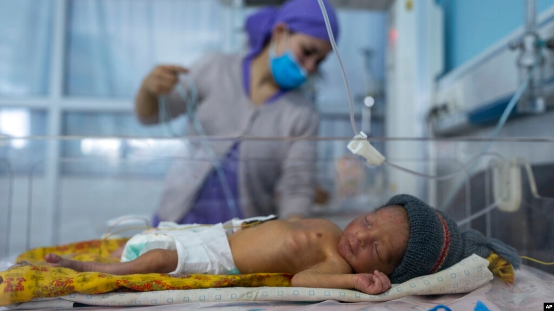 FILE - A nurse takes care of a baby in the neonatal intensive care unit of Malalai Maternity hospital in Kabul, Afghanistan, Dec. 9, 2021.