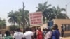 Youths protest against French President Emmanuel Macron's declarations over how Cameroon is handling the conflict in its English-speaking regions, outside the French embassy in Yaounde, Feb. 24, 2020. (Moki Edwin Kindzeka/VOA)