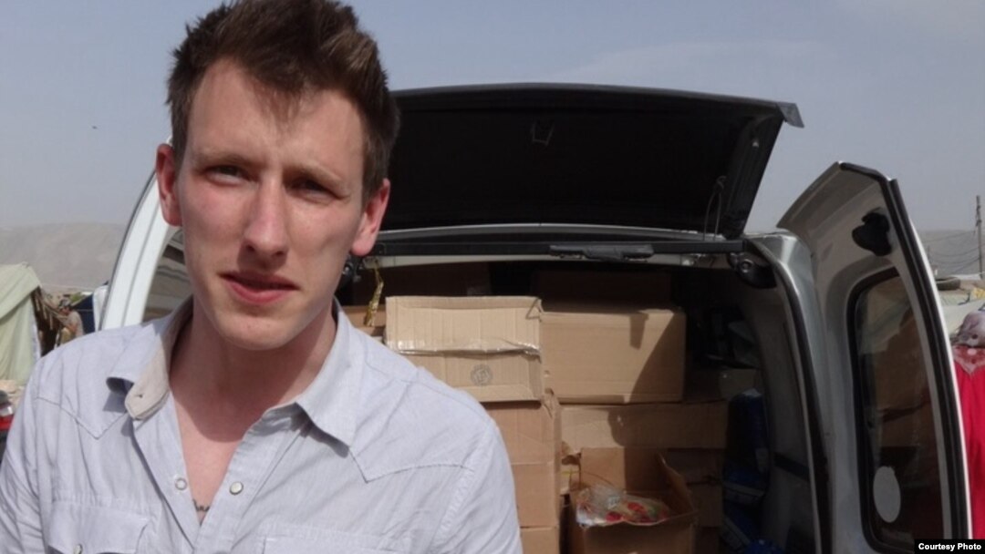 FILE - Abdul-Rahman (Peter) Kassig, an American aid worker, making a food delivery to refugees in Lebanon’s Bekaa Valley, May 2013. Kassig is a being held captive by Islamic State militants. (Courtesy of Kassig family)