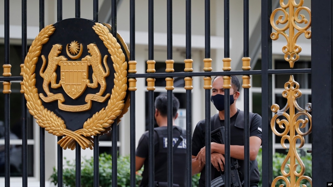 Police guard the back entrance at the national palace in Kuala Lumpur, Malaysia, Aug. 19, 2021.