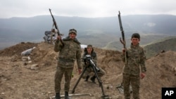 FILE - Armenian soldiers pose near a frontline in Nagorno-Karabakh, Azerbaijan, April 6, 2016. 