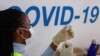 A dose of AstraZeneca vaccine is prepared at COVID-19 vaccination center in the Odeon Luxe Cinema in Maidstone, Britain, Feb. 10, 2021. 