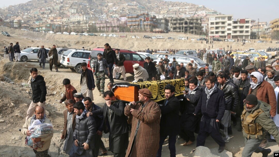 FILE - Men carry the coffin of a relative who died in the Jan. 27 deadly suicide attack in Kabul, Afghanistan. At a recent Senate hearing on top U.S. security threats, the word “Afghanistan” was spoken exactly four times, and in two hours, no senator asked about Afghanistan.