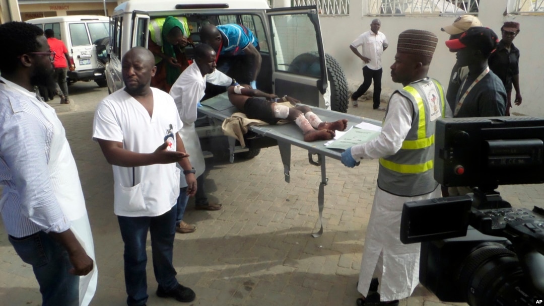 FILE - Health officials loads an injured person into an ambulance following a suicide attack in Damboa, Borno Nigeria, June 17, 2018.
