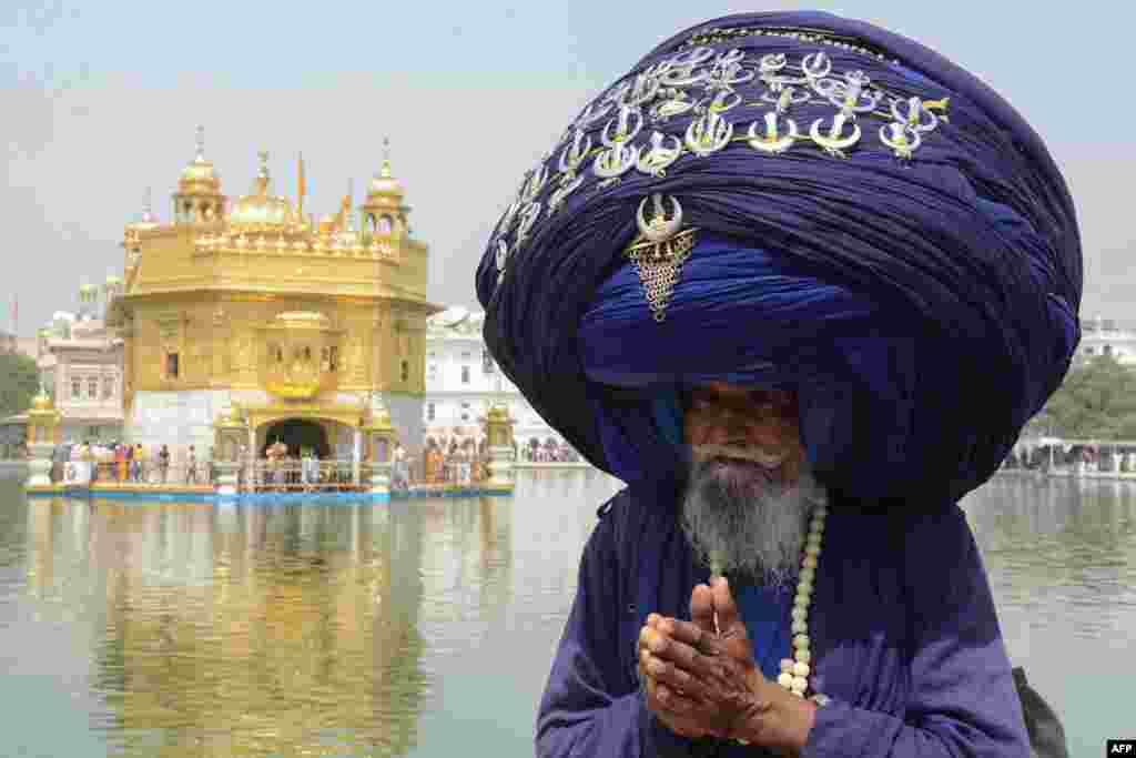 Indian Sikh Nihang (a traditional Sikh religious warrior) Baba 'Jagir' Singh wears a giant turban at the Golden Temple in Amritsar on the eve of the 397th birth anniversary of the ninth Sikh Guru Teg Bahadur.