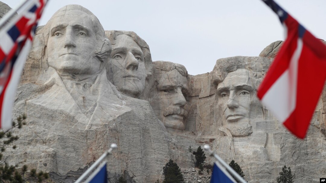 FILE - Flags frame the presidents on the Mount Rushmore monument, Dec. 9, 2016, near Keystone, S.D.