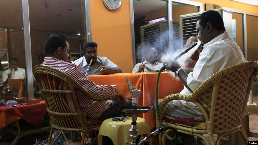 Customers smoke water pipes at a shisha cafe in Khartoum, April 28, 2013