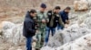 A Lebanese army personnel inspects the remains of a shell that was launched from Lebanon to Israel, which according to activists landed 500m from the Lebanese-Israeli border, in the southern Lebanese village of Sarada, Dec. 29, 2013. 