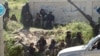This image posted on the Twitter page of Syria's al-Qaida-linked al-Nusra Front shows fighters from the group in the town of Jisr al-Shughour, Idlib province, Syria, April 25, 2015.