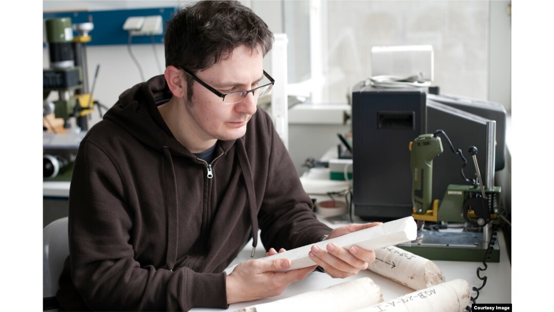Paleo-climatologist Thomas Felis in his laboratory at the Center for Marine Environmental Sciences University of Bremen Germany inspects core samples from the Great Barrier Reef dating from the peak of the last ice age 20,000 years ago. (Credit: Volker Di