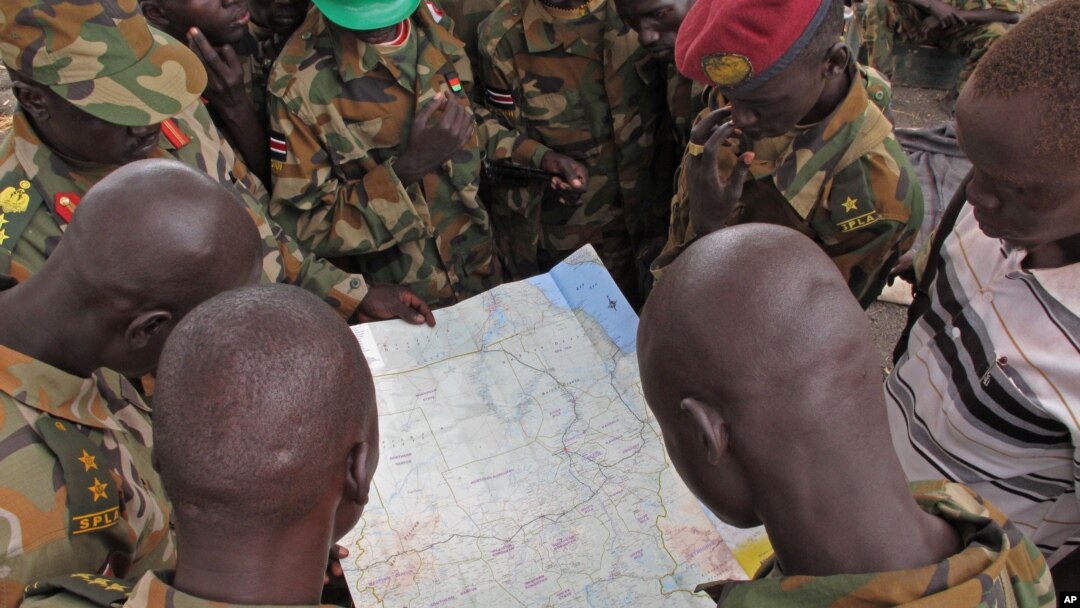 FILE - Soldiers from the Sudan People's Liberation Army (SPLA) are seen examining a map in Pana Kuach, Unity State, South Sudan.