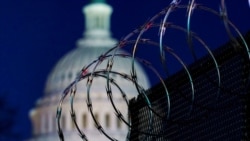 FILE - Riot fencing and razor wire reinforce the security zone on Capitol Hill in Washington, Jan. 19, 2021. Capitol Police say they are stepping up security at D.C.-area transit hubs and taking other steps to bolster travel security for lawmakers.