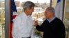 U.S. Secretary of State John Kerry (L) talks to Israeli Prime Minister Benjamin Netanyahu during a meeting from a room overlooking the snow-covered city of Jerusalem, Dec. 13, 2013.