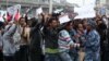 A policeman attempts to control protesters chanting slogans during a demonstration over what they say is unfair distribution of wealth in the country at Meskel Square in Ethiopia's capital Addis Ababa, Aug. 6, 2016. 