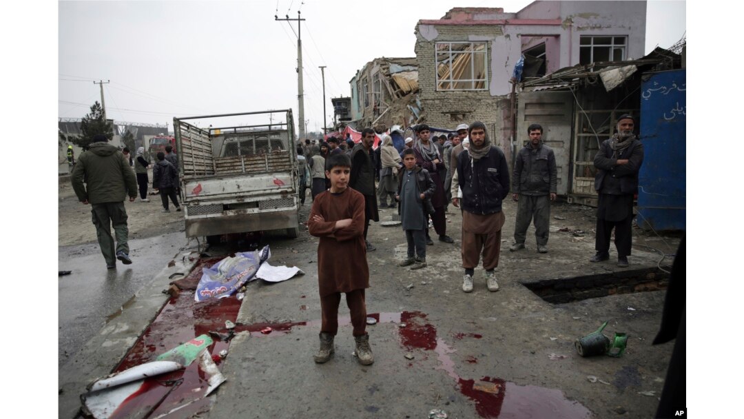 Residents walk through the site of a suicide attack in Kabul, Afghanistan, March 2, 2018. A large explosion in the eastern part of the Afghan capital on Friday morning killed at least one and wounding others officials said.