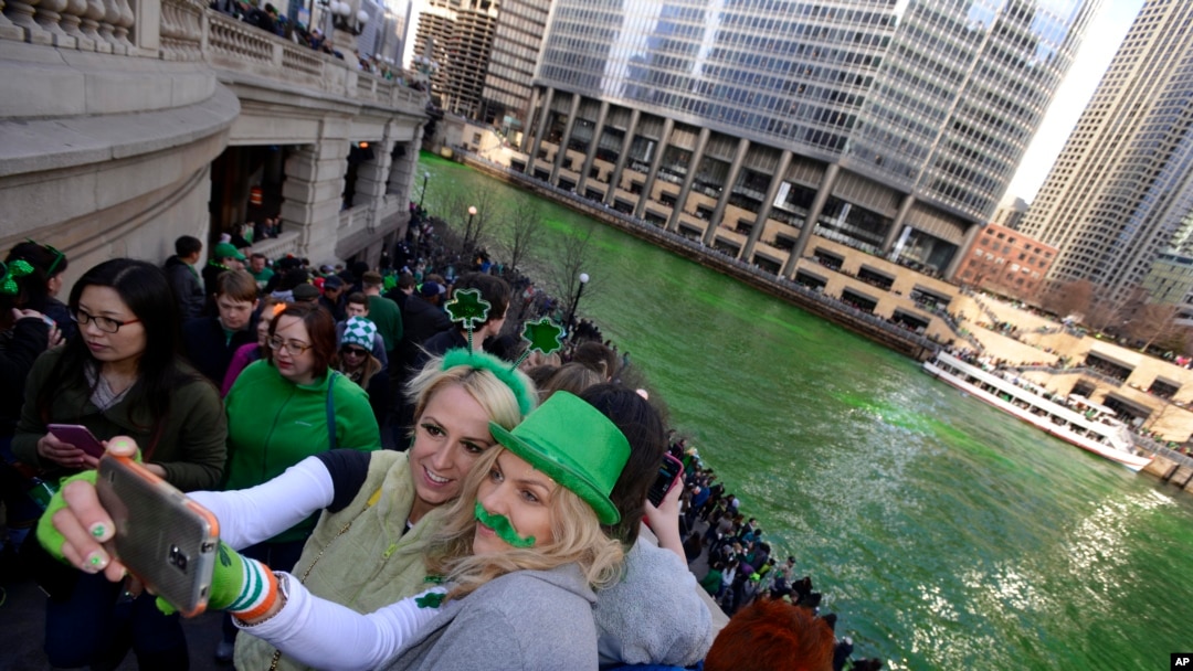 Chicago residents take a selfie after the Chicago River is dyed green ahead of the St. Patrick's Day parade.