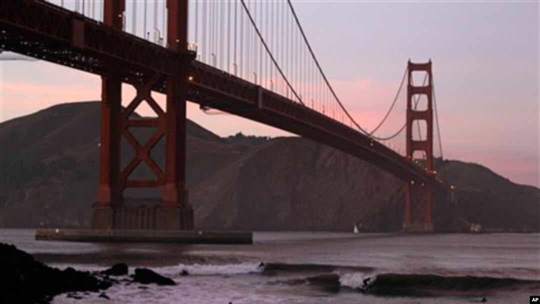 Surfers catch waves late in the day under the Golden Gate Bridge in San Francisco, Wednesday, Jan. 19, 2011. (AP Photo/Eric Risberg)