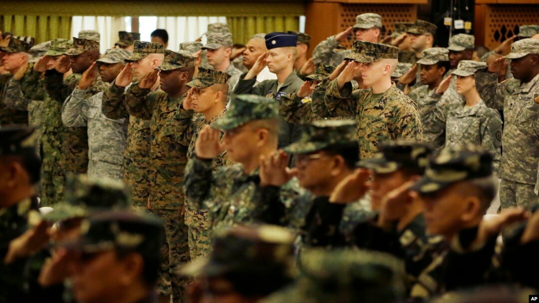 U.S. and Philippine troops salute during the opening ceremony of their joint military exercise dubbed "Balikatan 2015" at Camp Aguinaldo at suburban Quezon city, northeast of Manila, Philippines, April 20, 2015.