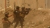 Security forces defend their headquarters against attacks by Islamic State extremists during sand storm in the eastern part of Ramadi, the capital of Anbar province, Iraq, May 14, 2015.