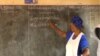 A teacher writes in Ewondo, one of Cameroon's national languages, at a school in Yaounde, Feb. 21, 2020. (Moki Edwin Kindzeka/VOA)