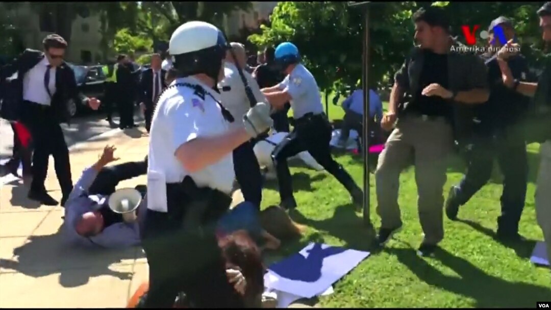 FILE - Police in Washington try to break up a clash between protesters and supporters of Turkish President Recep Tayyip Erdogan near the Turkish ambassador's residence, May 16, 2017.