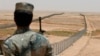 FILE - A member of the Saudi border guards force watches Saudi Arabia's northern borderline July 14, 2014. 