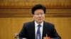 中共新疆自治区党委书记张春贤3月10日在人大会议新疆组会上回答问题。