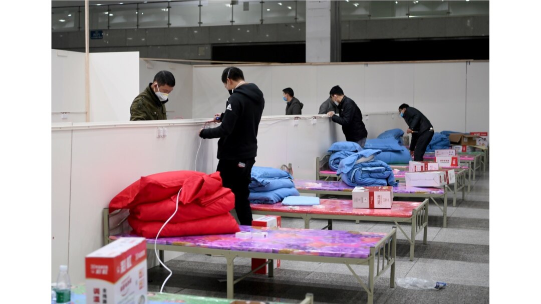 Workers set up infrastructure at the Wuhan International Conference and Exhibition Center to convert it into a makeshift hospital to receive patients infected with the new coronavirus, in Wuhan, Hubei province, China February 4, 2020.